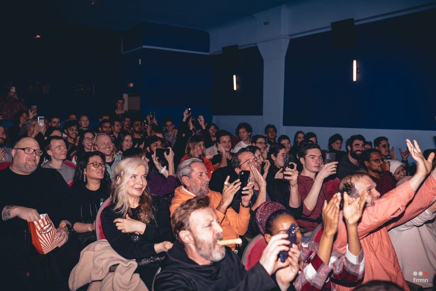 A full house reacts during a screening.